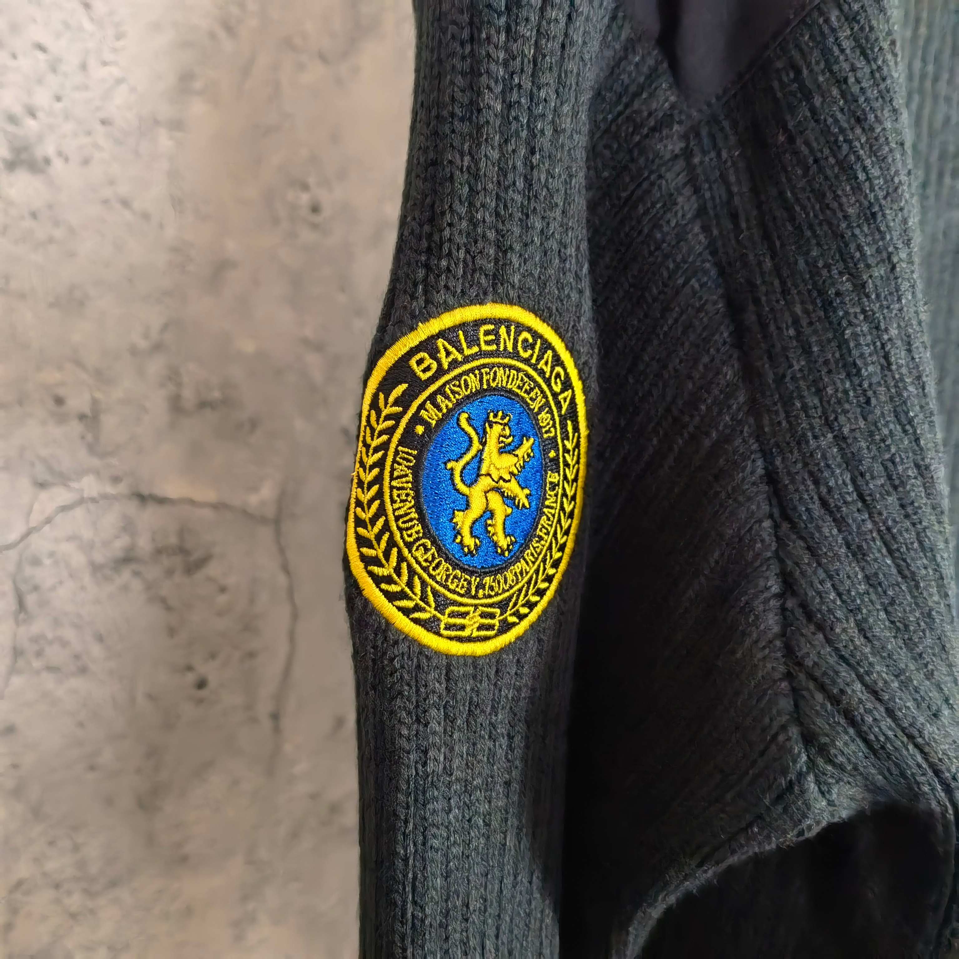 Balenciaga knit sweater arm crest patch with blue lion inside yellow circular seal