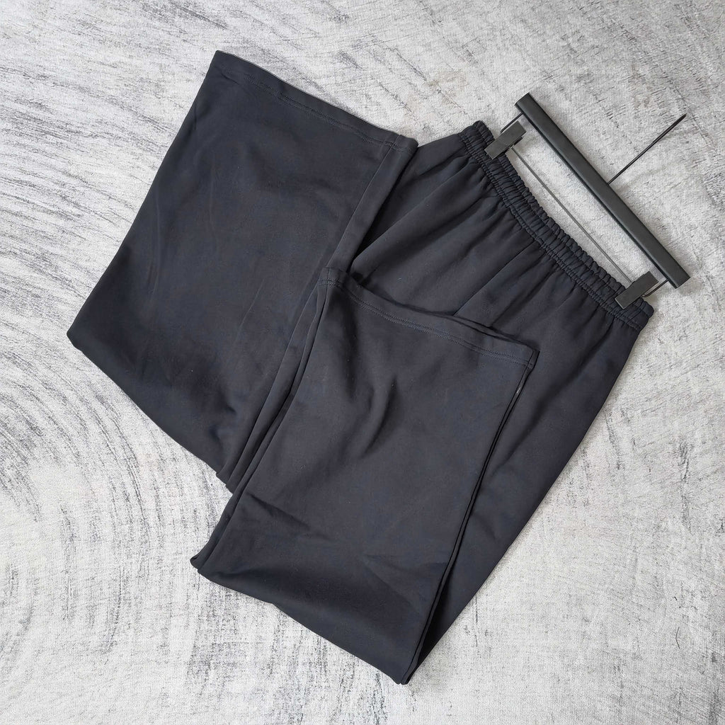 Balenciaga black pants on hangers, elastic waistband, relaxed wide-leg cut
