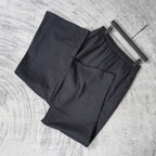 Balenciaga black pants on hangers, elastic waistband, relaxed wide-leg cut
