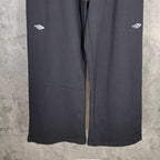 Balenciaga black wide-leg pants, straight hem detail and small side logo markings