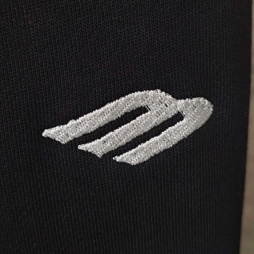 Balenciaga side stripe logo on black fabric, two light embroidered bands