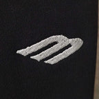 Balenciaga side stripe logo on black fabric, two light embroidered bands