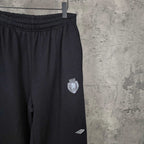 Balenciaga pants with elastic waistband, dark fabric, side pocket and crest patch