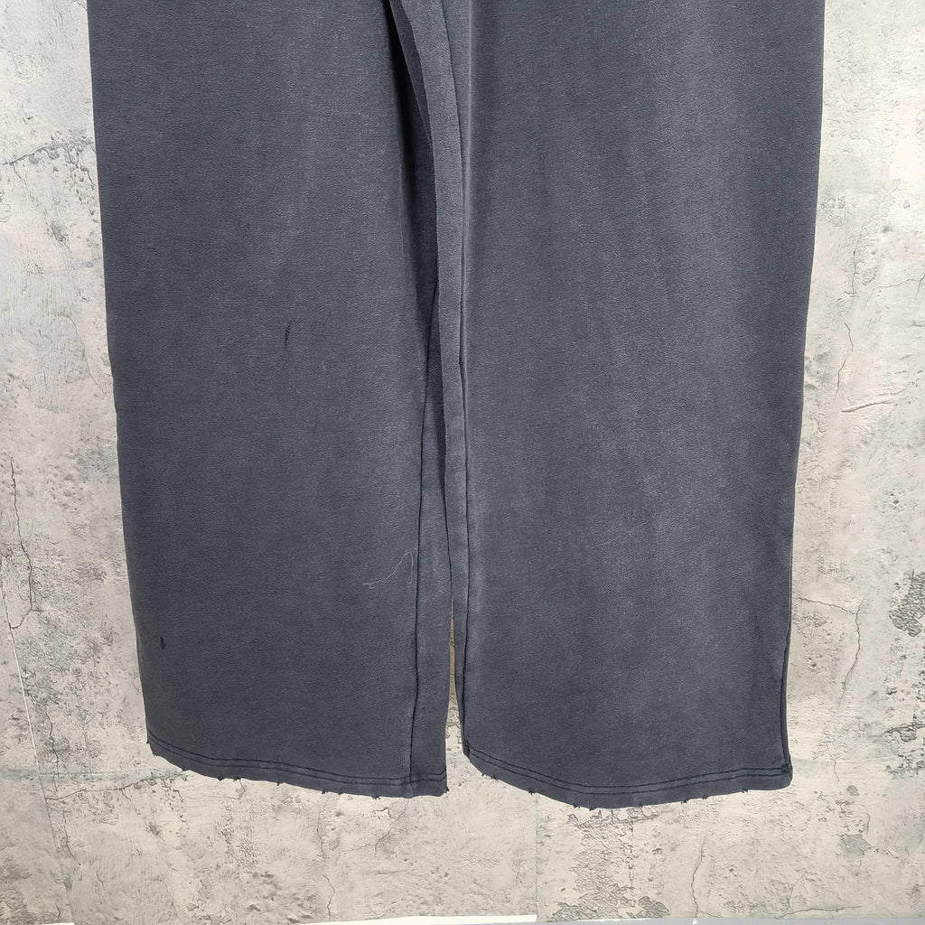 Dark wide-leg sweatpants hem with straight cuffs and visible seam details.