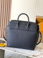 Louis Vuitton black leather handbag with two top handles and front flap detail