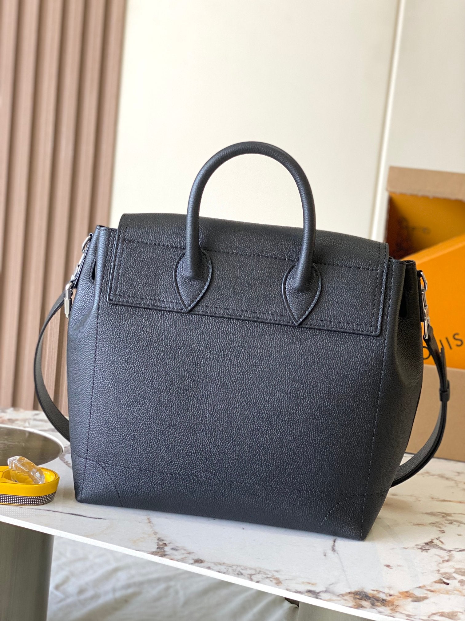 Louis Vuitton black leather handbag with two top handles and front flap detail