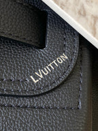 Louis Vuitton black leather handbag with embossed logo on textured grain