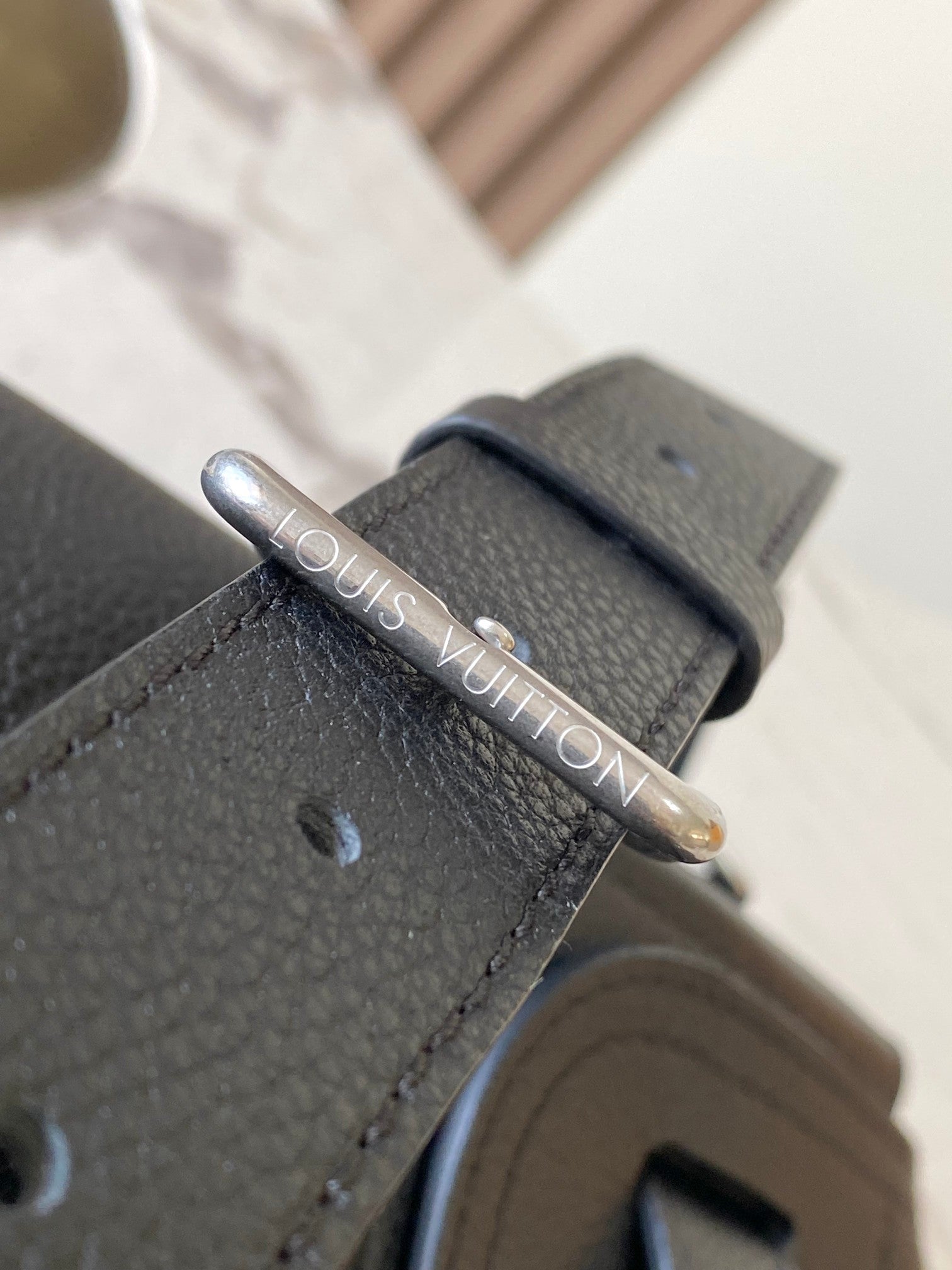 Louis Vuitton black leather handbag with silver logo snap ring detail