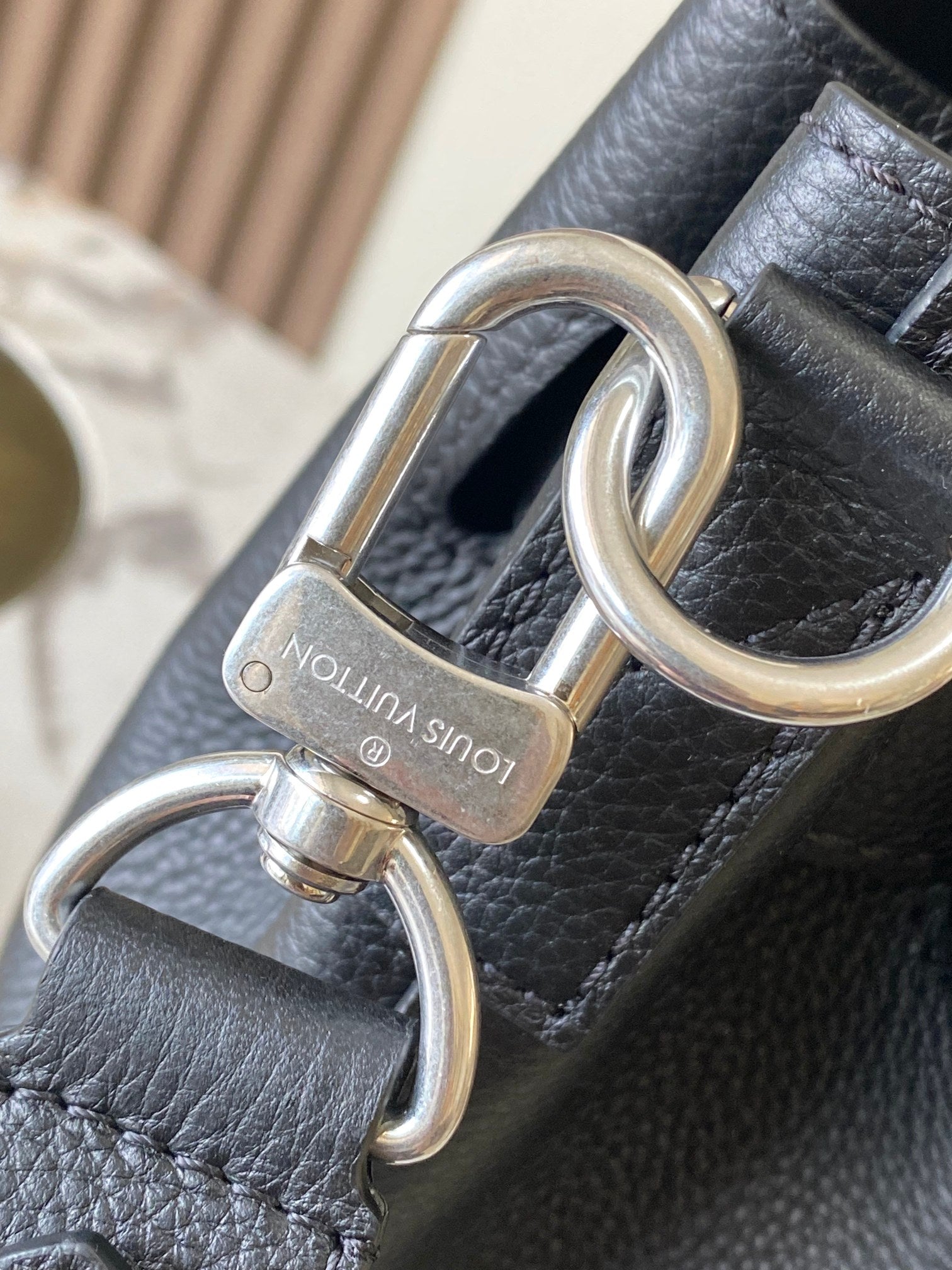 Louis Vuitton black leather handbag with silver key ring hardware and lock