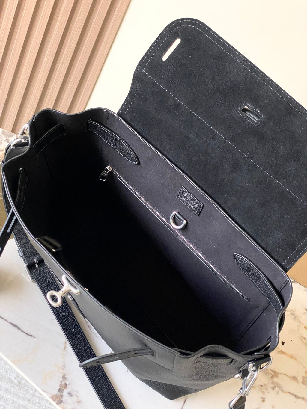 Louis Vuitton black leather handbag open interior with front pocket and shoulder strap