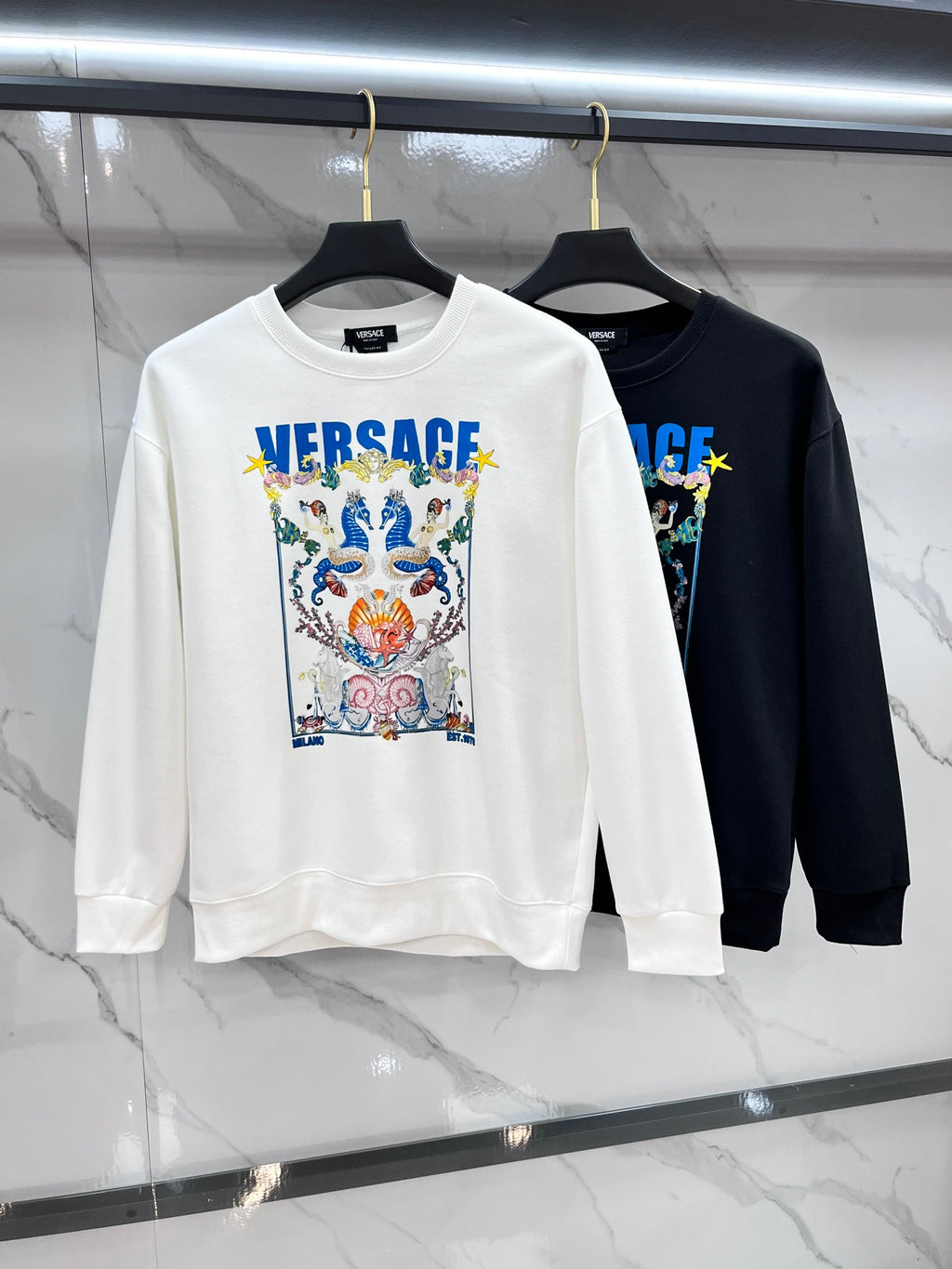 Versace crewneck sweatshirts, white and dark/black, with colorful front crest graphics