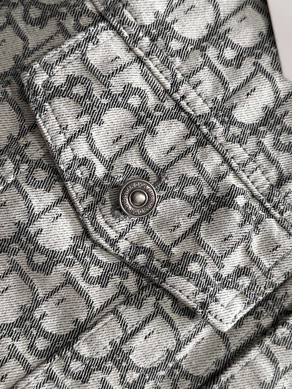 Logo-print jacket shoulder yoke detail with round metal snap button