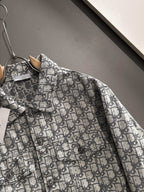 Long-sleeve logo-print jacket close-up at chest pocket and button placket