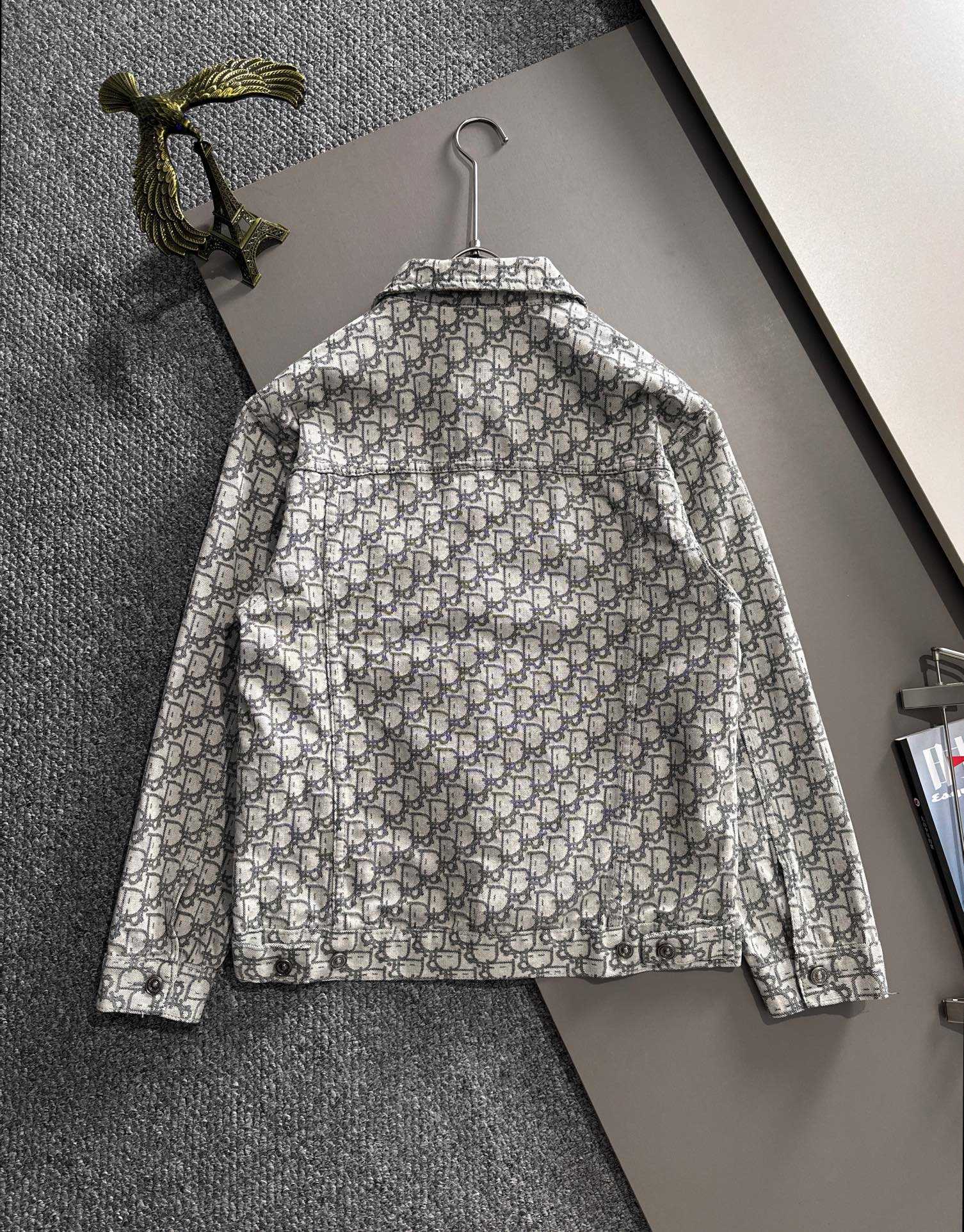 Back view of long-sleeve jacket with allover logo print and button closure