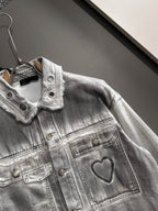 Light denim dress detail with snap buttons and heart emblem on chest pocket