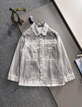 White denim dress with collared neckline, snap buttons, and heart patch pocket detail