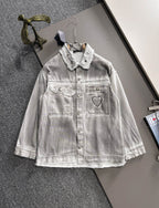 White denim dress with collared neckline, snap buttons, and heart patch pocket detail
