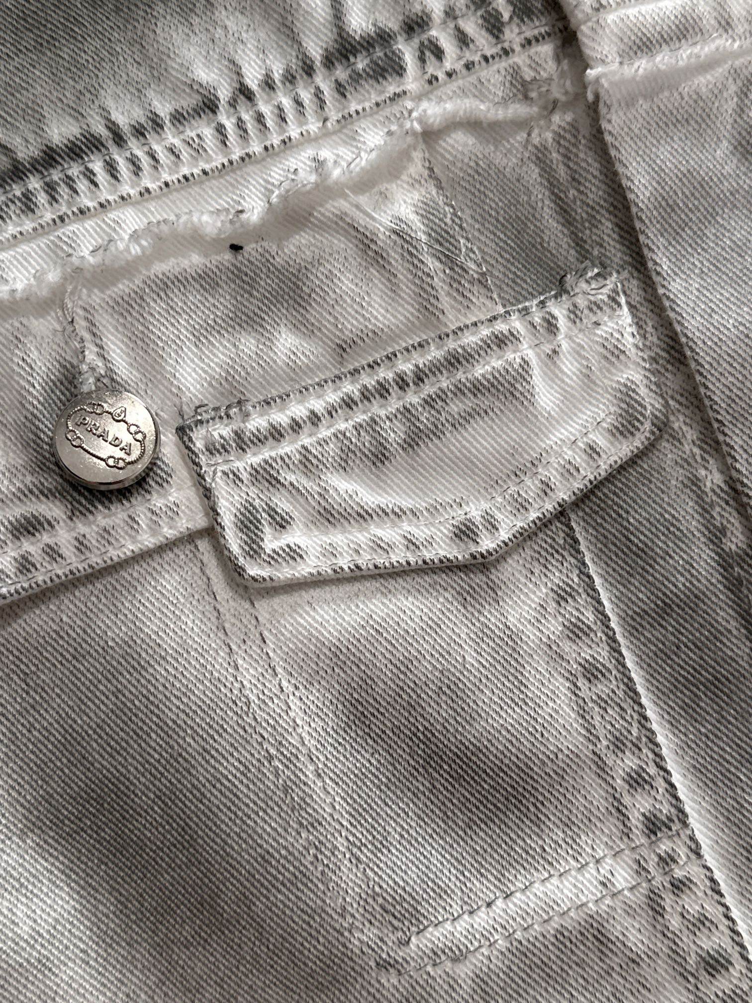 Light denim dress close-up of front pocket with stitched heart and button tab