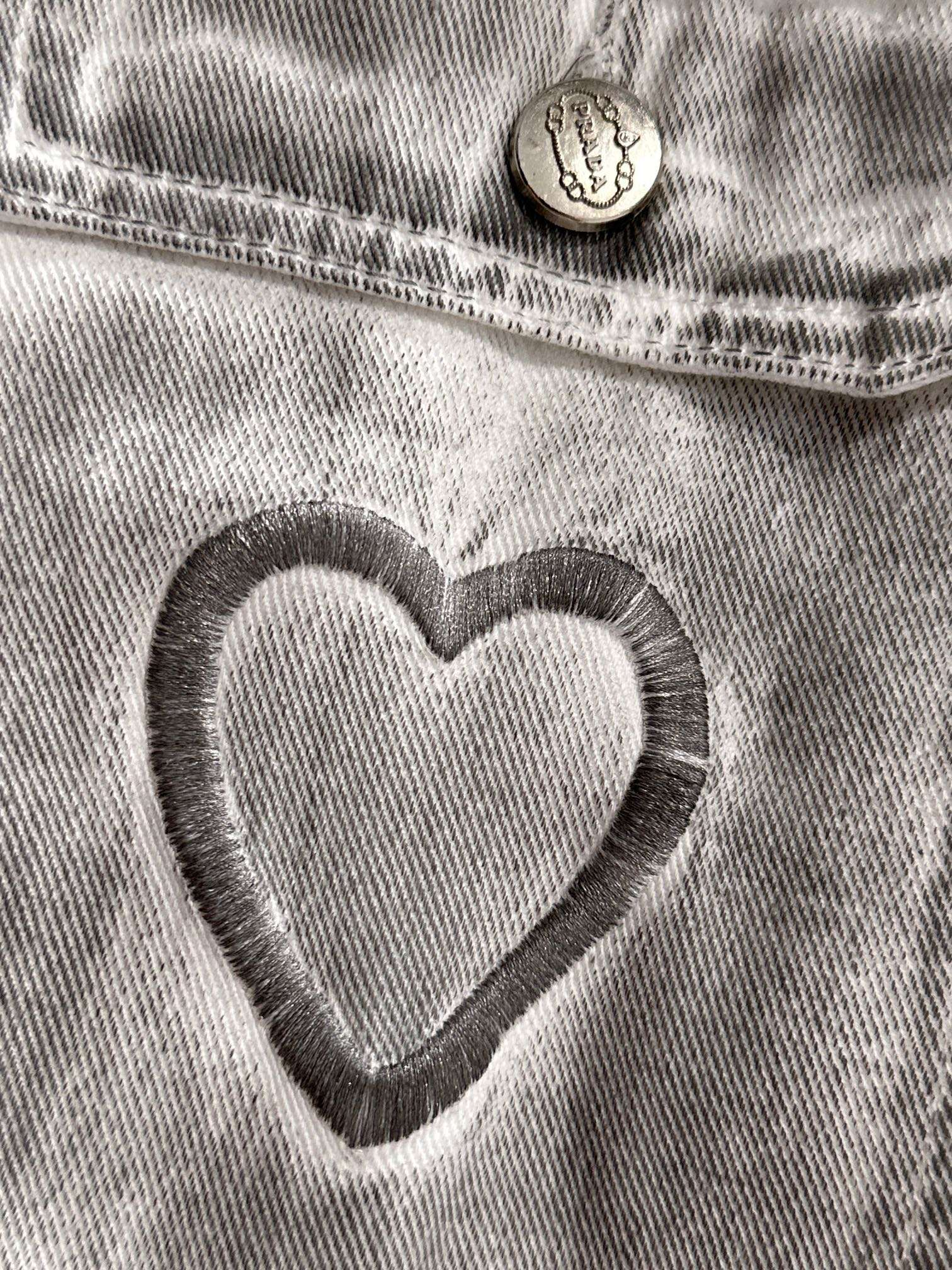 Light denim dress close-up of heart applique on chest pocket with round button