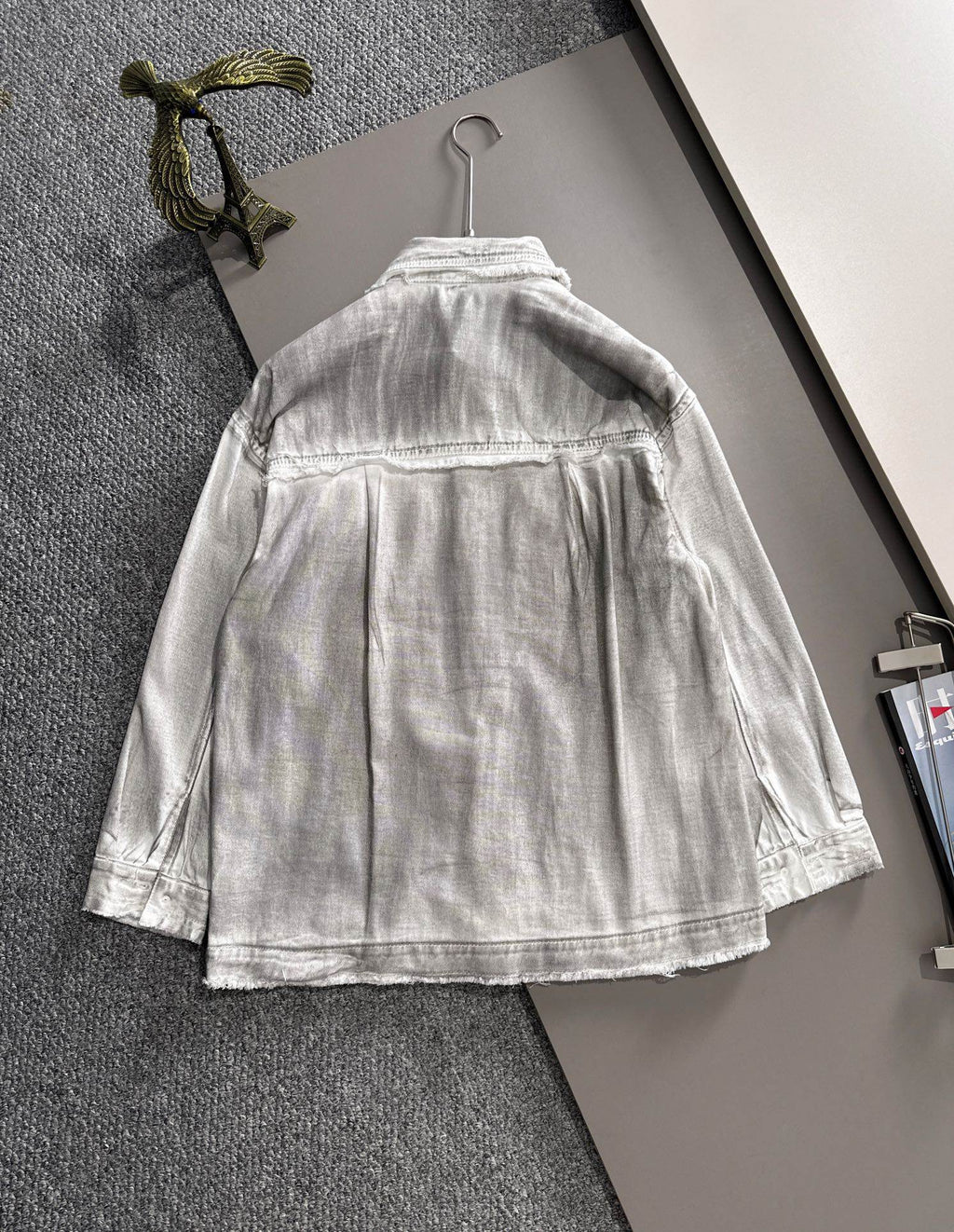 Back view of light denim dress with button placket and gathered skirt hem