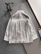 Back view of light denim dress with button placket and gathered skirt hem