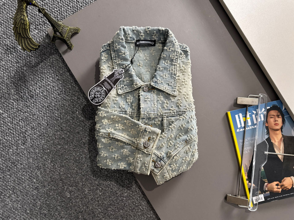 Light blue denim jacket with floral embroidery, button front, chest flap and welt pockets