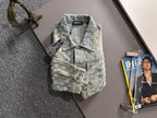 Light blue denim jacket with floral embroidery, button front, chest flap and welt pockets