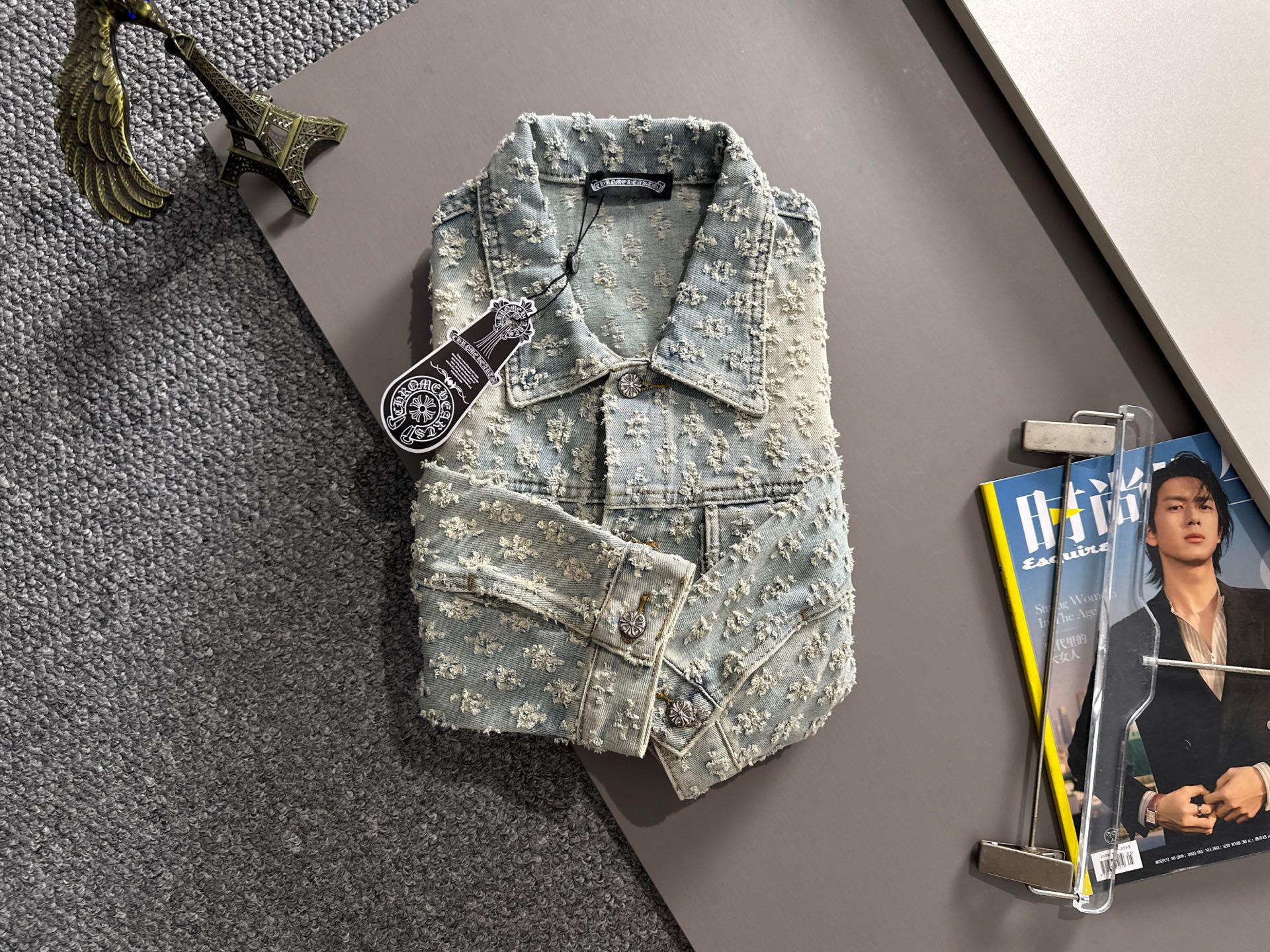 Light blue denim jacket with floral embroidery, button front, chest flap and welt pockets