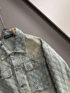 Light blue denim jacket front detail with floral embroidery, collar, and button placket