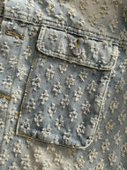 Denim jacket yoke and chest pocket with floral embroidery and stitched trim