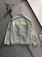 Light blue denim jacket back view with floral embroidery, yoke seam, and button closures