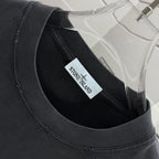 Black T-shirt neckline with small brand label tag
