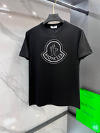 Black T-shirt with rhinestone crest logo on the chest