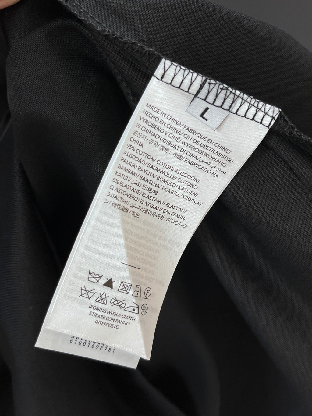 Black T-shirt interior care label near the waistband