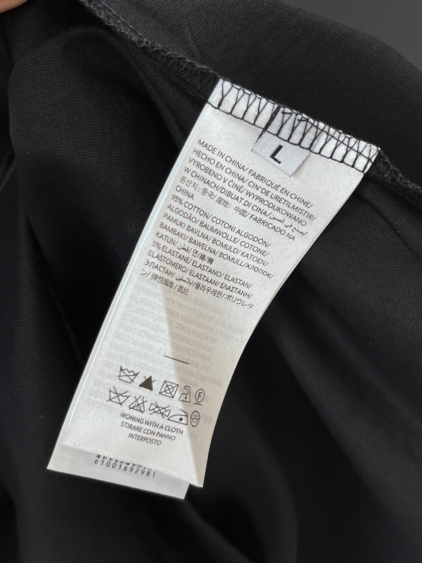 Black T-shirt interior care label near the waistband