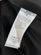 Black T-shirt close-up of care label and size information