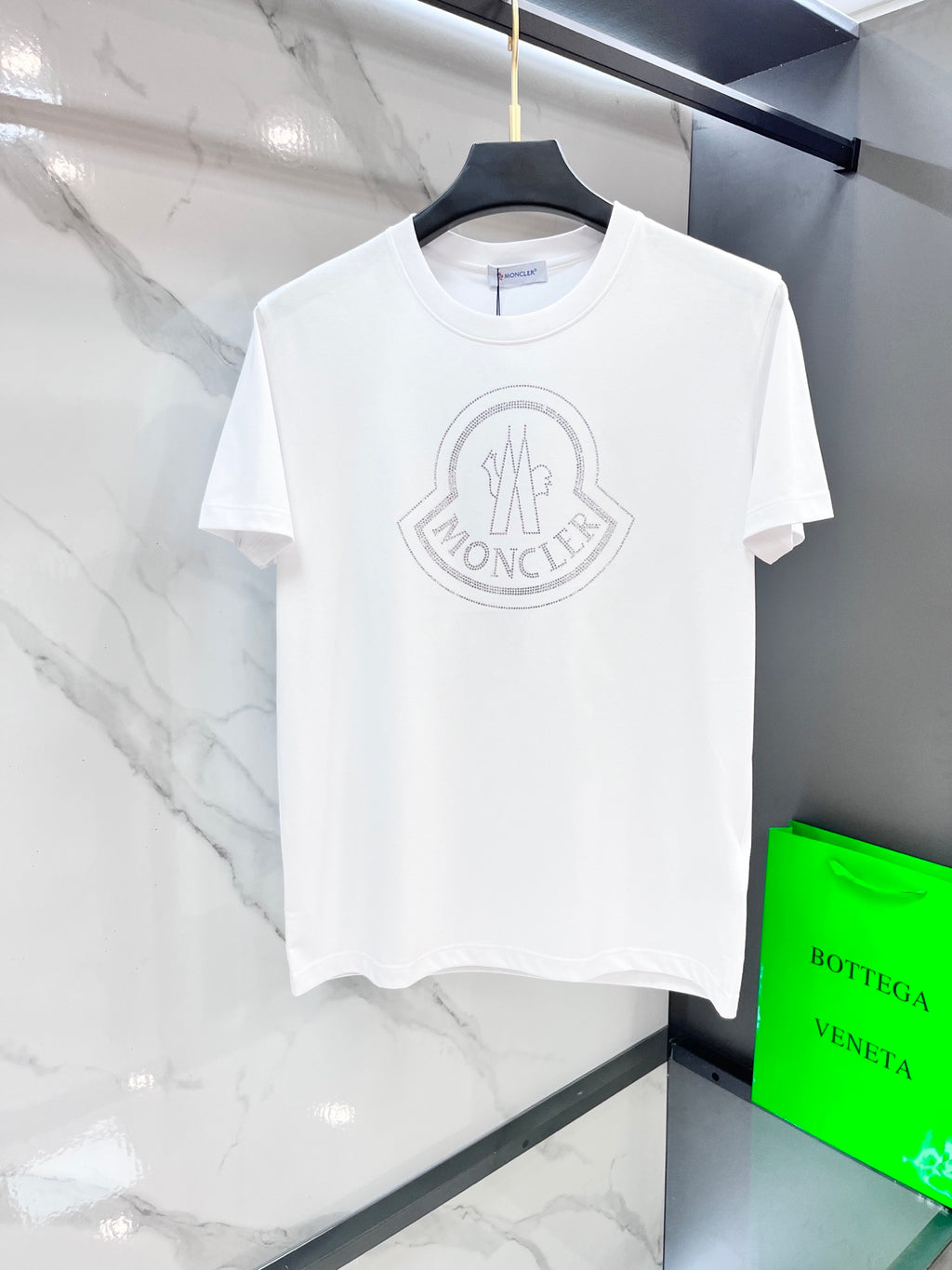 White T-shirt with Moncler circular logo on the chest.