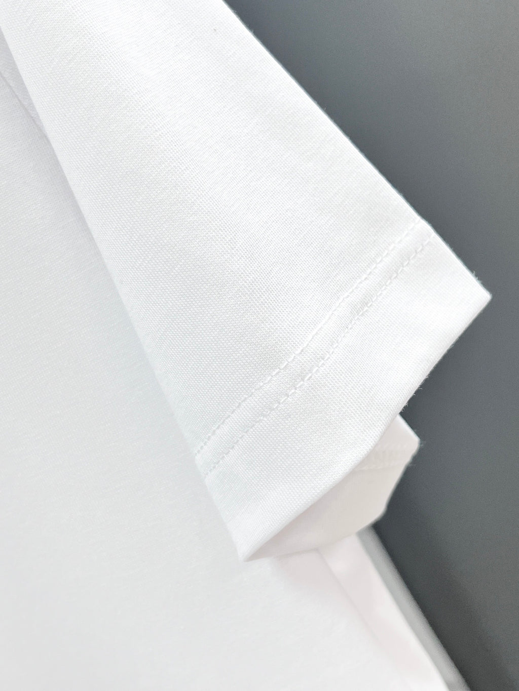 White T-shirt sleeve and side seam close-up