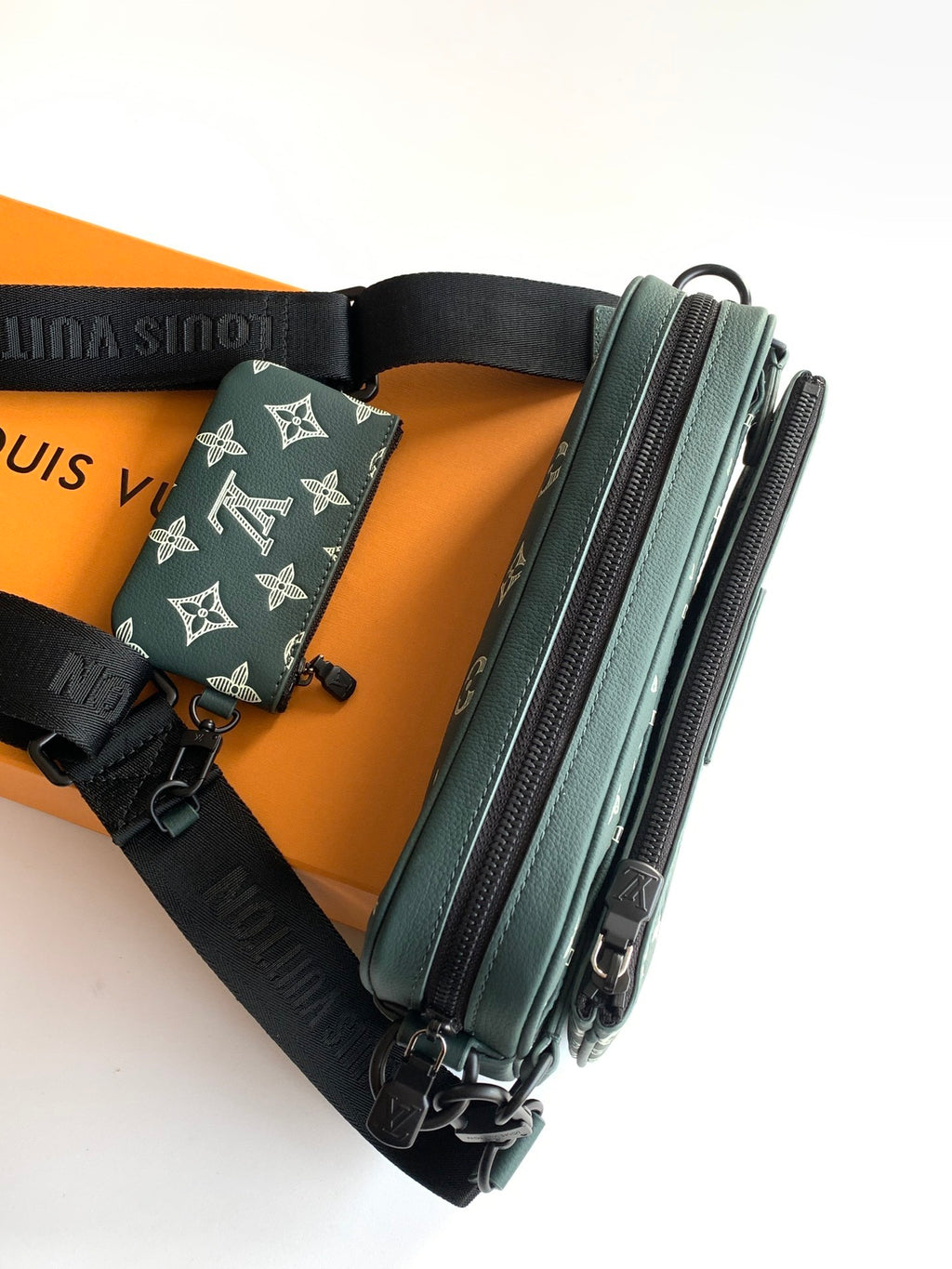 Louis Vuitton teal monogram belt bag style with black adjustable strap and dual zips