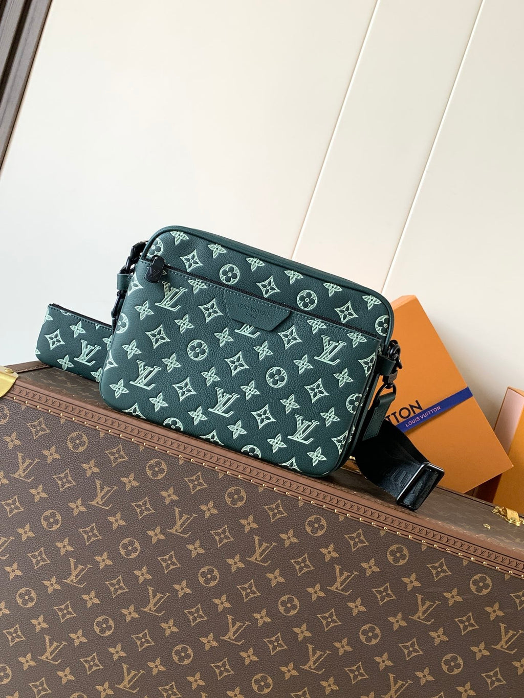 Louis Vuitton teal monogram crossbody bag with adjustable black strap and zip top