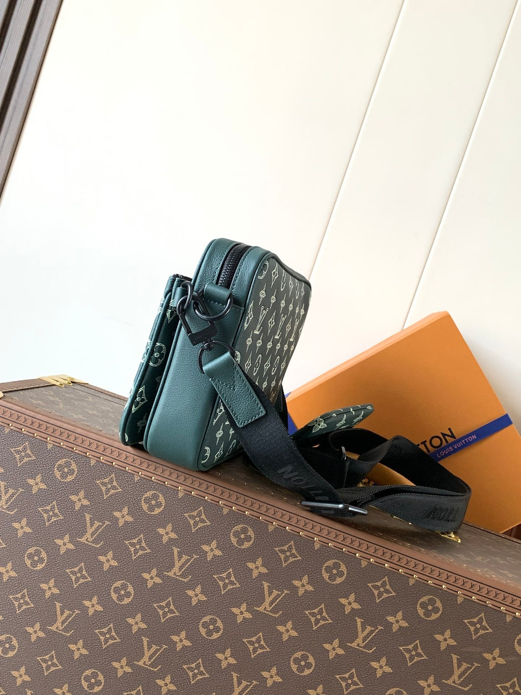 Louis Vuitton teal monogram shoulder bag with flap front, black strap, and side pocket