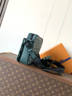 Louis Vuitton teal monogram shoulder bag with flap front, black strap, and side pocket
