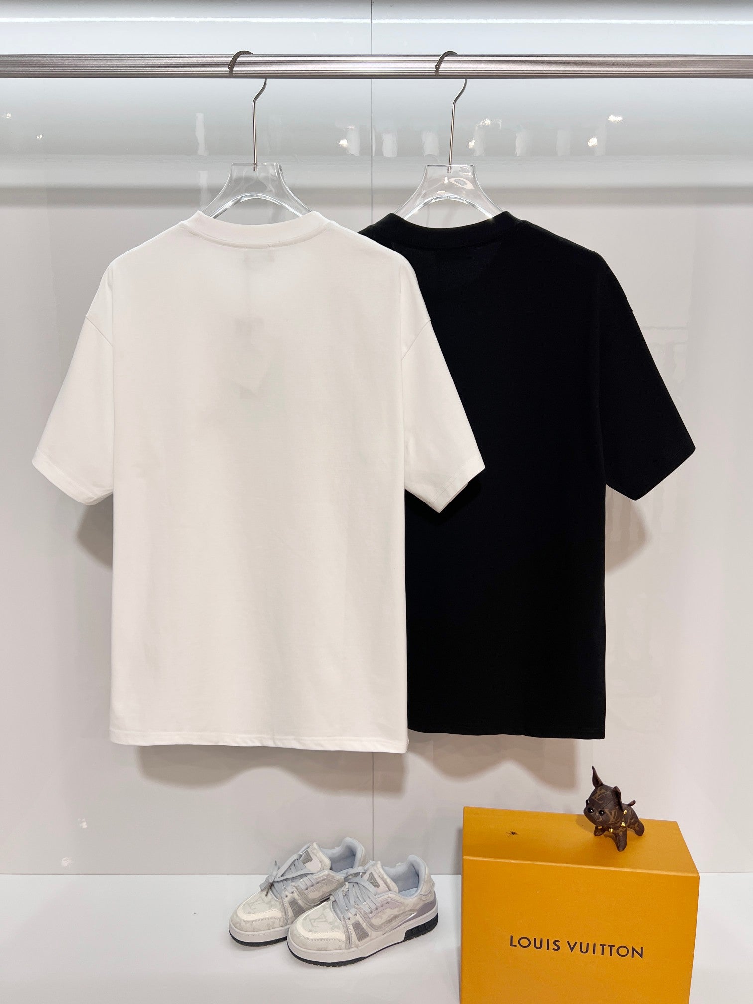 Dior short-sleeve T-shirts, white and black on hangers