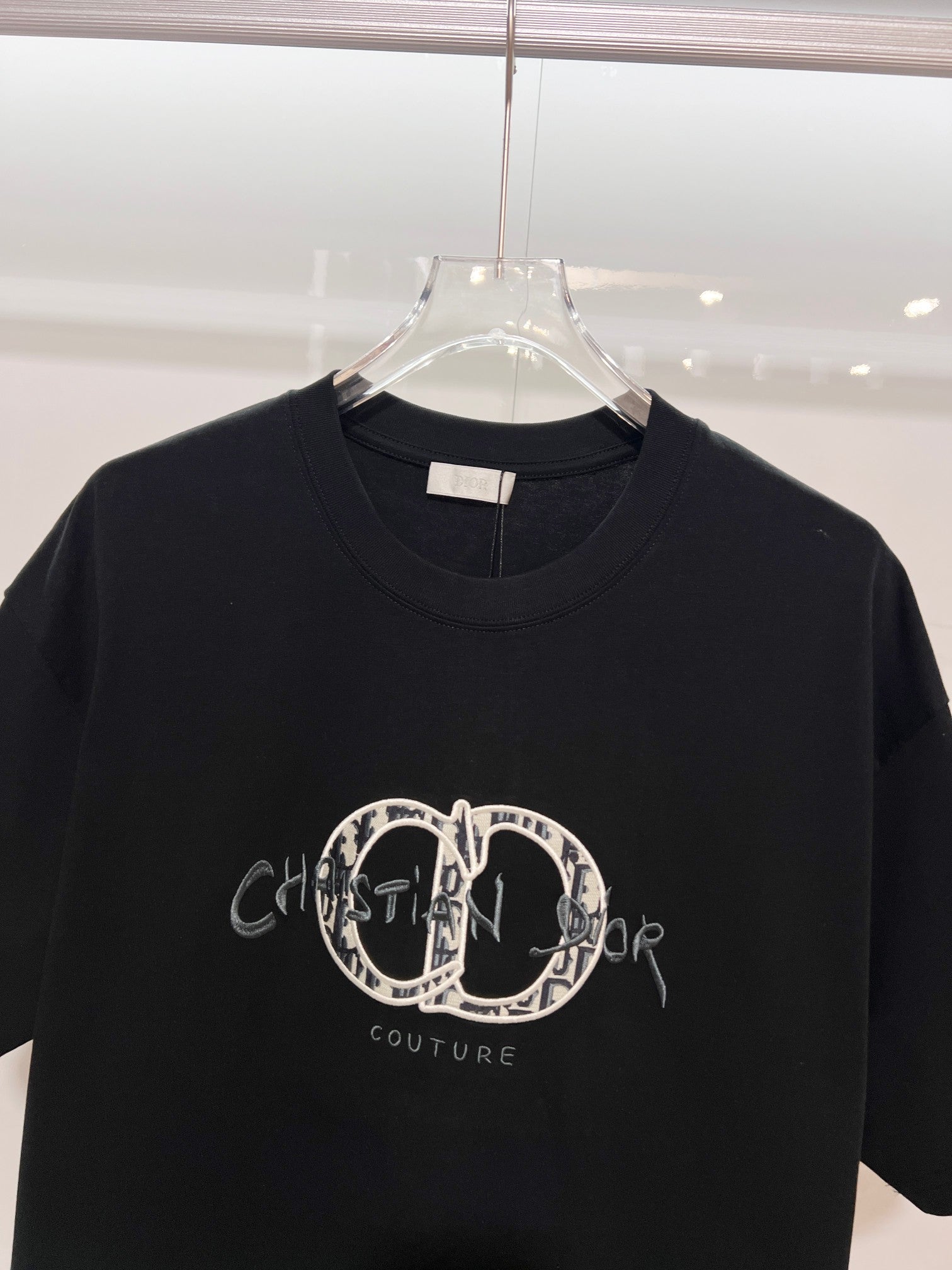 Black Dior crew-neck T-shirt with embroidered oval logo and 'Couture' text on chest