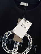 Black Dior T-shirt with hanging white tag at crew neckline