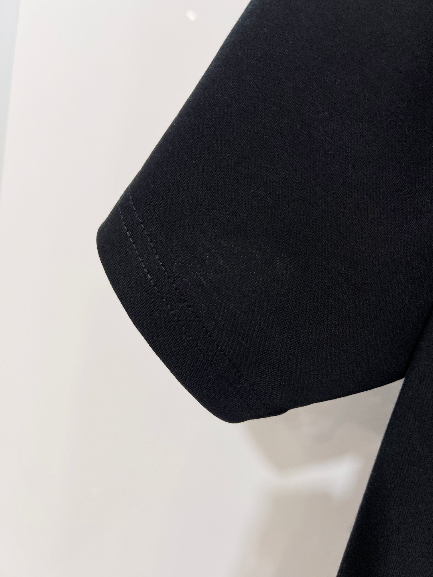 Black Dior T-shirt sleeve hem detail