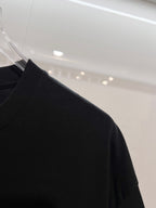 Black T-shirt shoulder and sleeve in side view