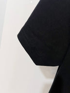 Black T-shirt hem and side seam detail