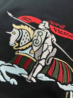 Black T-shirt close-up of horse illustration with red and green stripes