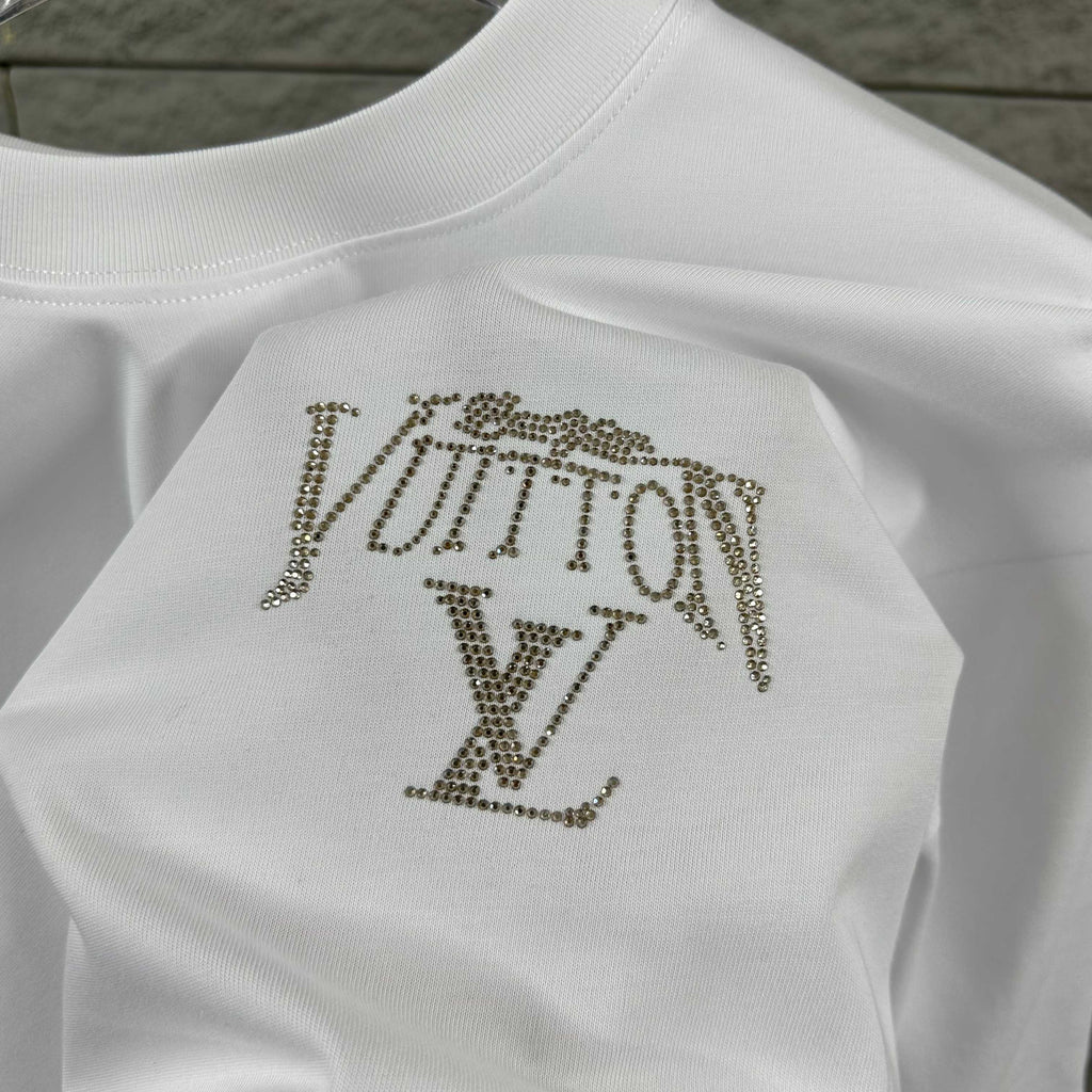 Close-up of white Louis Vuitton T-shirt with rhinestone LV logo on back